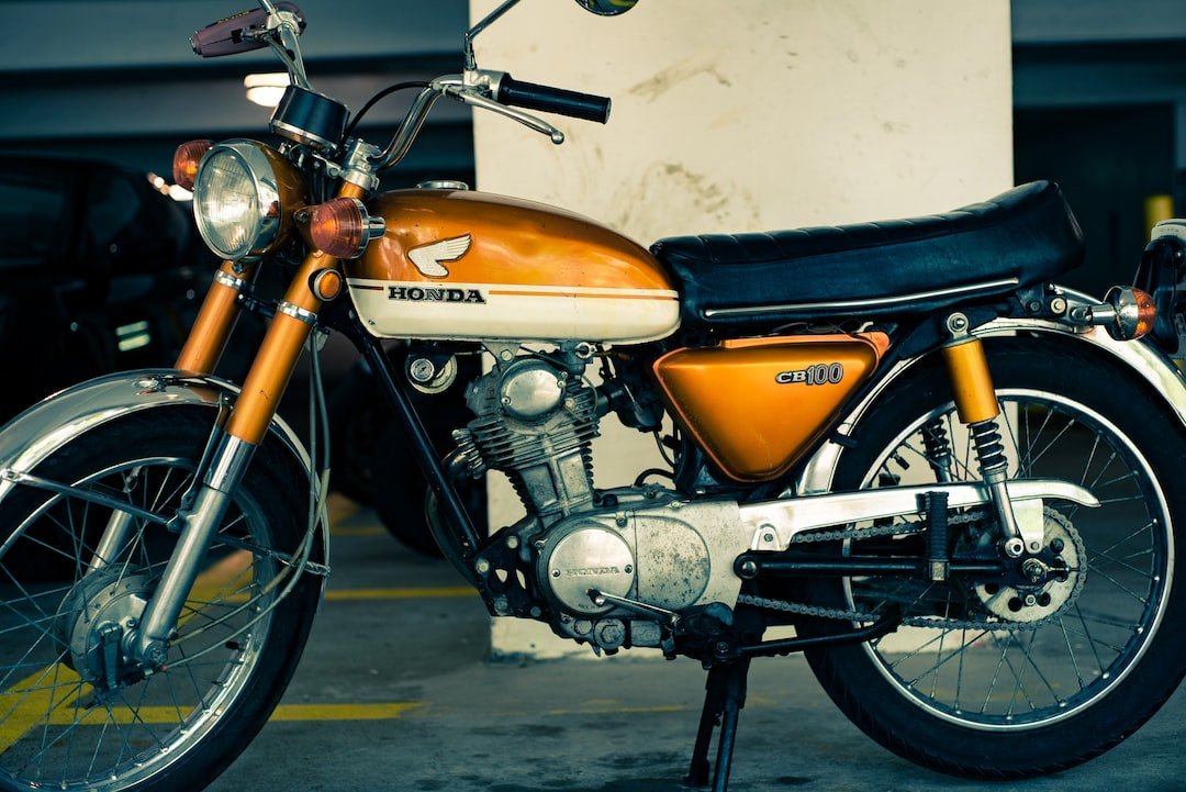 orange and black Honda standard motorcycle